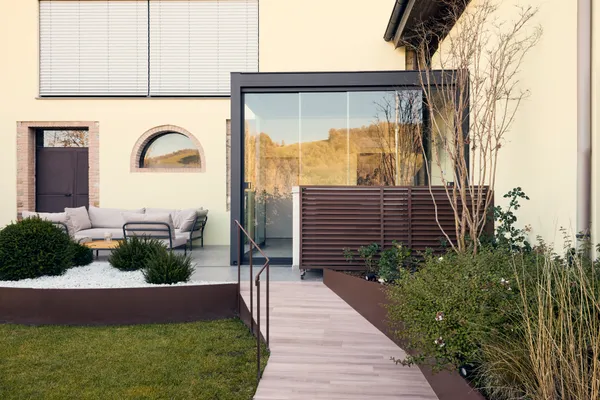 Glass canopy over stone stairs.